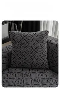 Detail of soft yarn-dyed jacquard fabric with geometric diamond pattern on sofa cover