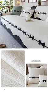 Detail of cream white chenille sofa cushion with black bow accents and wavy edging
