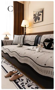 Detail of cream chenille sofa cover with black wavy lines and small heart patterns