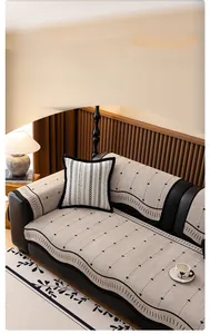 Close-up of beige chenille sofa cover showing 3D textured patterns and geometric motifs