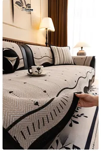 Close-up of beige chenille sofa cover with black wave edge and knit texture detail