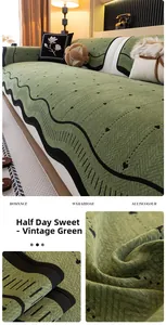 Detail of retro green chenille sofa cover with heart embroidery and wavy black edging