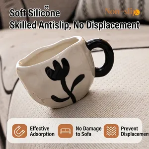 White anti-slip silicone tulip mug with thick black handle on textured chenille sofa