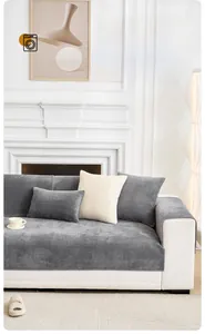Detail of gray thickened milk velvet sofa cover with non-slip texture and matching pillows