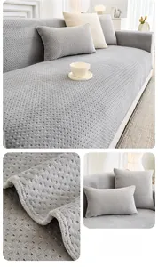 Detail of light grey thickened milk fleece sofa cover with embossed dot texture