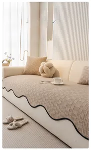 Detailed view of cream chenille sofa cushion with textured plaid and black wavy edges