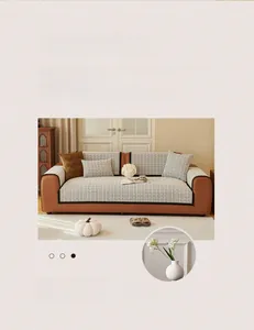 Détail de housse de canapé en chenille à motif pied-de-poule avec bordures noires chic