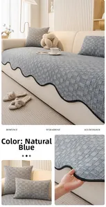 Close-up of thick grey-blue chenille sofa cushion with black wavy lace edges and checkered texture