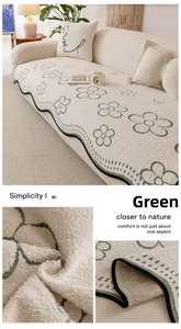 Detail of green floral pattern on soft off-white plush sofa cushion with non-slip back