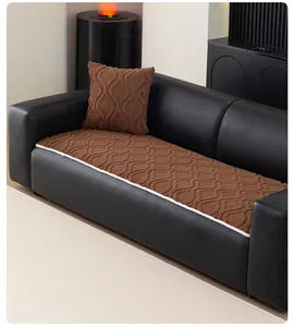 Close-up of brown plush sofa cushion with wave texture and white decorative piping