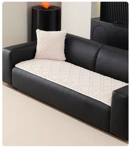 Close-up of cream sherpa fleece sofa cover with geometric texture on black leather