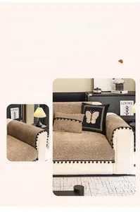 Close-up of heavy chenille sofa cover with coffee weave and black plush pom-poms