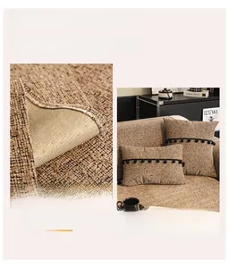 Detail of chenille sofa cover with non-slip backing and decorative pom-pom cushion