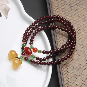 Triple-wrap garnet bead bracelet with yellow chalcedony gourds and agate accents