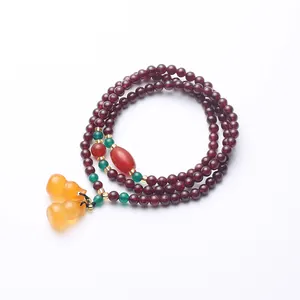 Three-layer garnet beaded bracelet with green spacer beads and twin gourd pendants