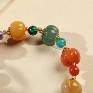 Natural pumpkin-shaped gold silk jade beaded bracelet with vintage charm and gourd pendant