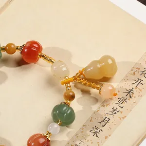 Natural pumpkin-shaped gemstone beads bracelet with gourd pendant and gold-tone spacers