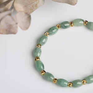 Natural light green oval jade bead bracelet with decorative engraved gold spacers