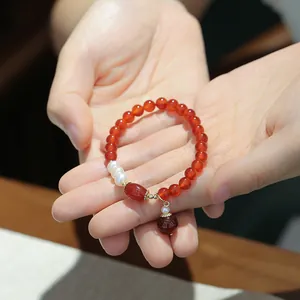 Elegant red agate bead bracelet with freshwater pearls and vintage gold charms