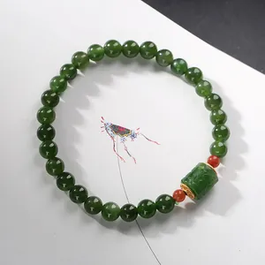 Natural green jasper beaded bracelet with hollow cylinder charm and gold accents