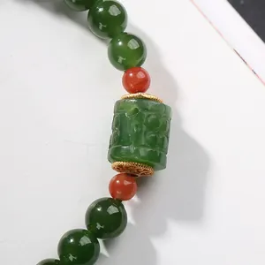 Natural jasper bead bracelet with carved cylinder bead and gold filigree spacers