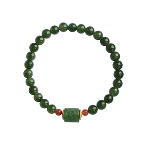 Natural green jasper beaded bracelet with vintage cylinder charm and red accents