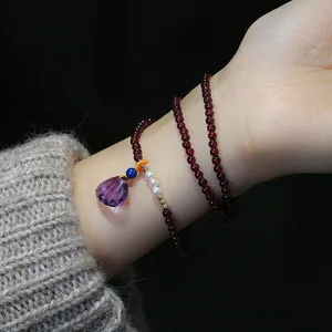 Three-layer garnet wrap bracelet with pearl accents and purple shell pendant for women