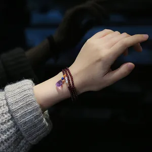 Three-layer garnet wrap bracelet with amethyst teardrop charm and pearl accents