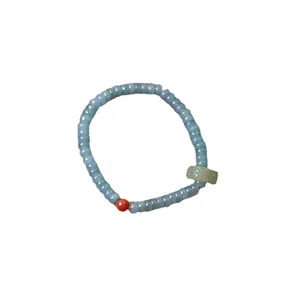 Blue jadeite abacus bead bracelet with green jade ring and red agate accent charm