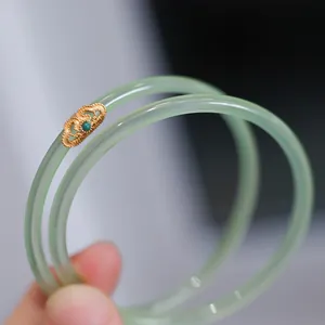 Elegant apple green chalcedony bangle set with intricate gold filigree and turquoise inlay