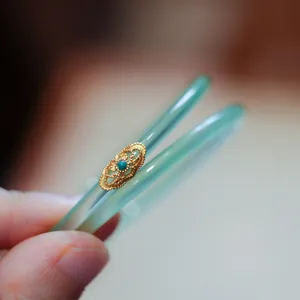 Translucent apple green jadeite bangles with gold filigree and turquoise inlay detail