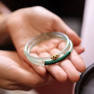 Translucent light green chalcedony bangle set with golden ruyi cloud charm and zircon
