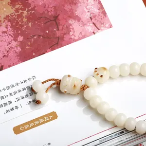 Bodhi seed bracelet featuring a cute cat paw charm with a brown hand-woven cord