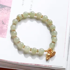 Natural Hetian jade beaded bracelet with lotus seed pod charms and gold accents
