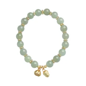 Natural Hetian jade beaded bracelet with gold lotus pendants on white background