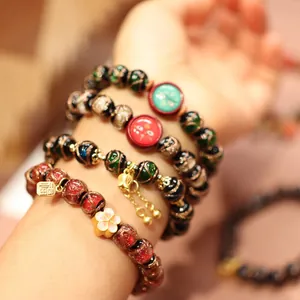 Multicolor layered glass bead bracelet with gold charms and hand-painted cat patterns