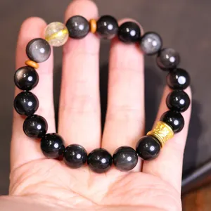 Pulsera de cuentas de obsidiana natural y cuarzo rutilado con pieza de metal dorado