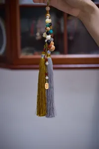 Macro shot of 18 seeds Bodhi car charm with colorful beads, flower pendant and tassels