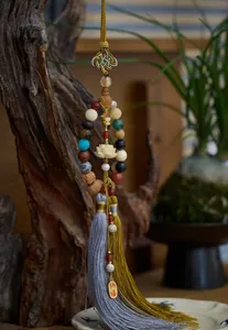 Detail of Buddhist prayer beads with lotus carving and elegant dual tassels