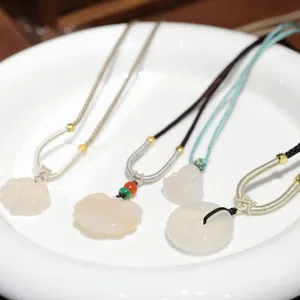 Translucent white chalcedony necklaces featuring lotus, Buddha, and donut-shaped pendants