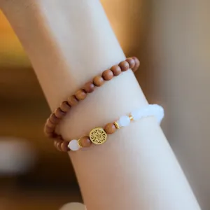Double-layered 6mm white jade and sandalwood bracelet with gold filigree cloud charm