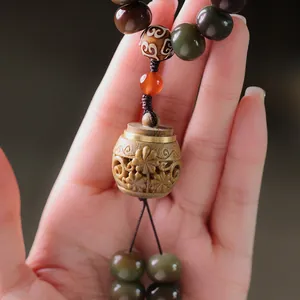 Handcrafted Bodhi root prayer beads with hollowed wood pendant and agate accents