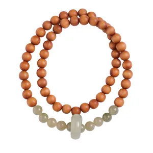 Double-layer sandalwood and jade beaded bracelet with a traditional Chinese ring pendant