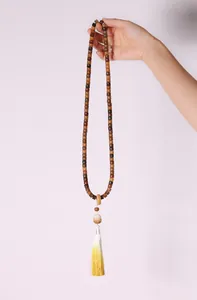 Detail of weathered white jade bodhi beads with a long silk tassel on a Chinese necklace