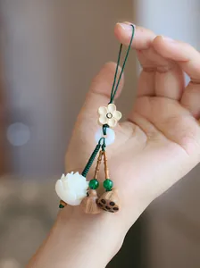 Exquisite lotus flower phone pendant featuring white resin lotus and wooden pod beads