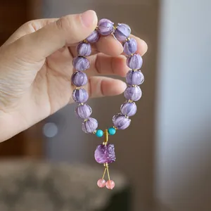 Purple glass bead bracelet with carved pumpkin pattern and traditional lion pendant