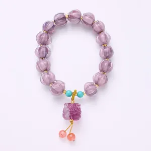 Handcrafted purple glass beaded bracelet with lion pendant and natural fluorite stones