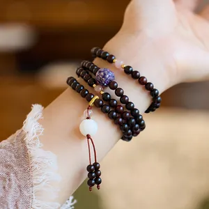 Natural sandalwood 108 beads bracelet with lotus pendant and silk tassel on wrist