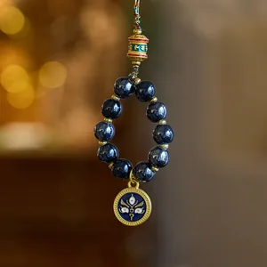 Detail of blue ceramic beads and gold-plated pendant in New Chinese style hanging