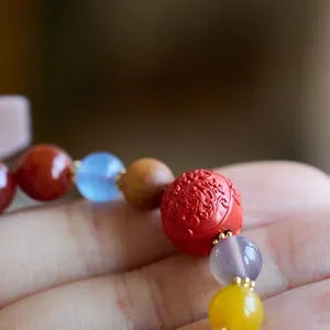 Gros plan sur des perles en agate dragon sculptées avec des séparateurs dorés raffinés